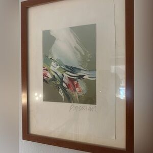 Signed art in a wood frame